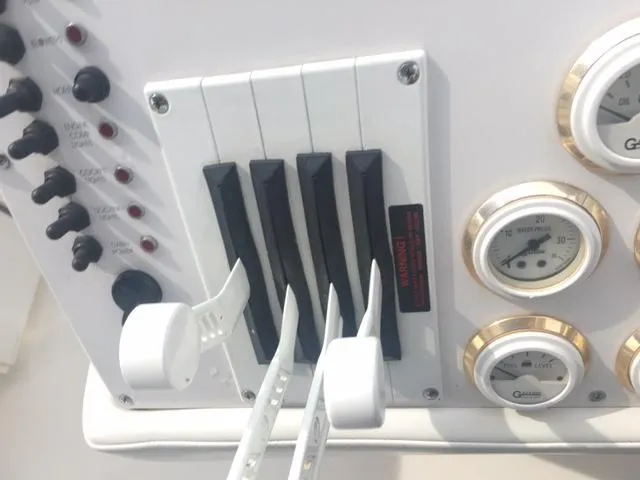 Slide: The Image of Control panel of a 2002 Fountain 38 Express Cruiser. - 16