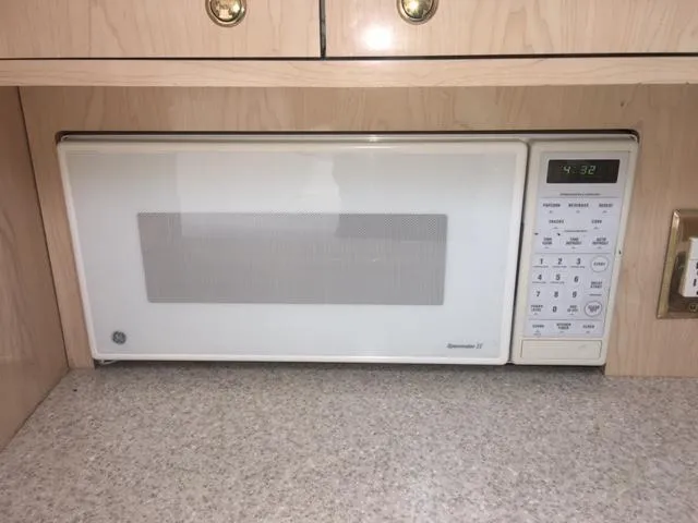 Slide: The Image of Microwave in the kitchen of a 2002 Fountain 38 Express Cruiser. - 27