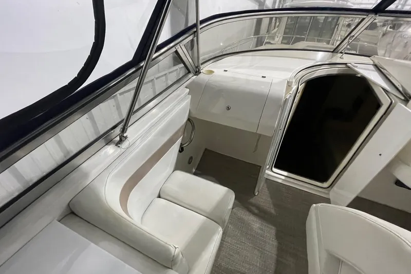Slide: The Image of 2002 Fountain 38 Express Cruiser interior with white seating and cabin entrance. - 7
