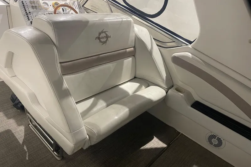 Slide: The Image of 2002 Fountain 38 Express Cruiser interior with white leather seating and control panel. - 9
