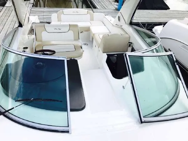 Slide: The Image of 2013 Sea Ray 310 Sundancer boat with open cockpit and seating area. - 11