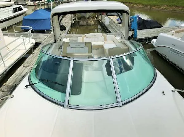 Slide: The Image of 2013 Sea Ray 310 Sundancer docked, featuring spacious seating and sleek design. - 12