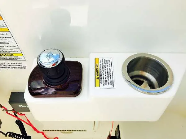 Slide: The Image of Control panel of 2013 Sea Ray 310 Sundancer boat with joystick and cup holder. - 19