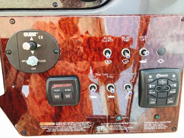 Slide: The Image of Control panel of a 2013 Sea Ray 310 Sundancer boat with various switches and indicators. - 21