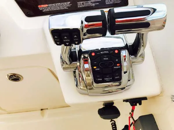 Slide: The Image of Close-up of 2013 Sea Ray 310 Sundancer throttle controls, featuring chrome finish and control buttons. - 22