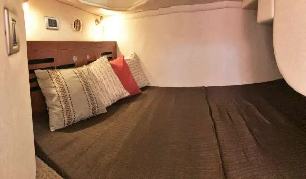 Slide: The Image of Cozy cabin interior of 2013 Sea Ray 310 Sundancer with pillows and ambient lighting. - 29