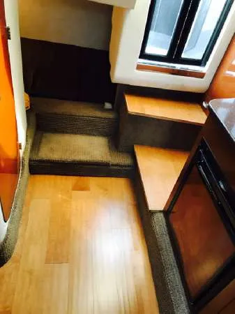 Slide: The Image of 2013 Sea Ray 310 Sundancer interior with wooden flooring and carpeted steps. - 33