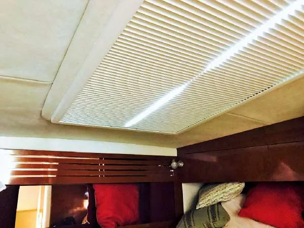 Slide: The Image of Interior cabin of 2013 Sea Ray 310 Sundancer with wooden accents and cozy bedding. - 40