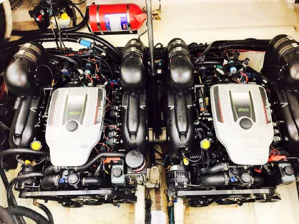Slide: The Image of Twin engines of a 2013 Sea Ray 310 Sundancer with visible fire extinguisher. - 42