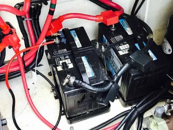 Slide: The Image of Batteries and wiring in a 2013 Sea Ray 310 Sundancer boat. - 44
