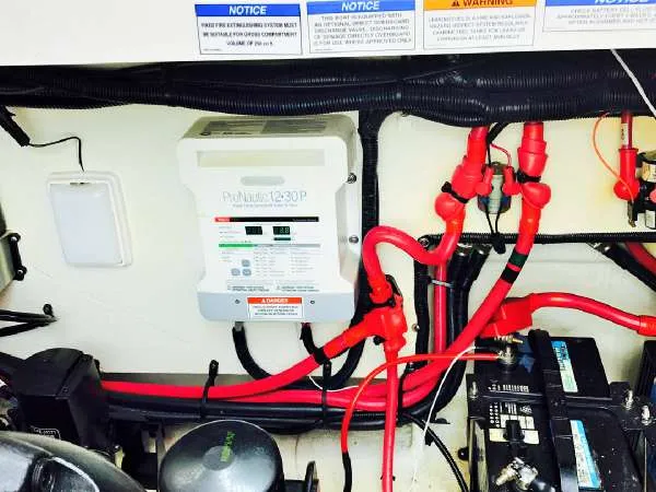 Slide: The Image of Engine compartment of 2013 Sea Ray 310 Sundancer with electrical components and wiring. - 45