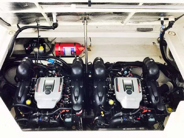 Slide: The Image of Engine compartment of 2013 Sea Ray 310 Sundancer with dual engines and fire extinguisher. - 47