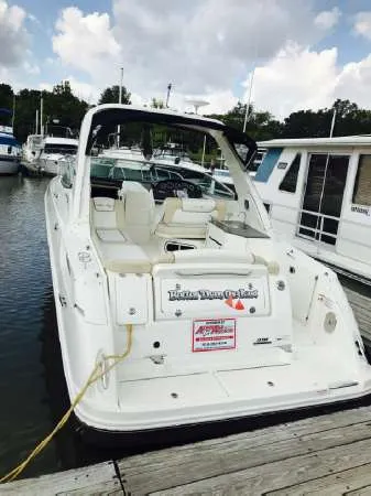 Slide: The Image of 2013 Sea Ray 310 Sundancer docked at marina, rear view. - 8