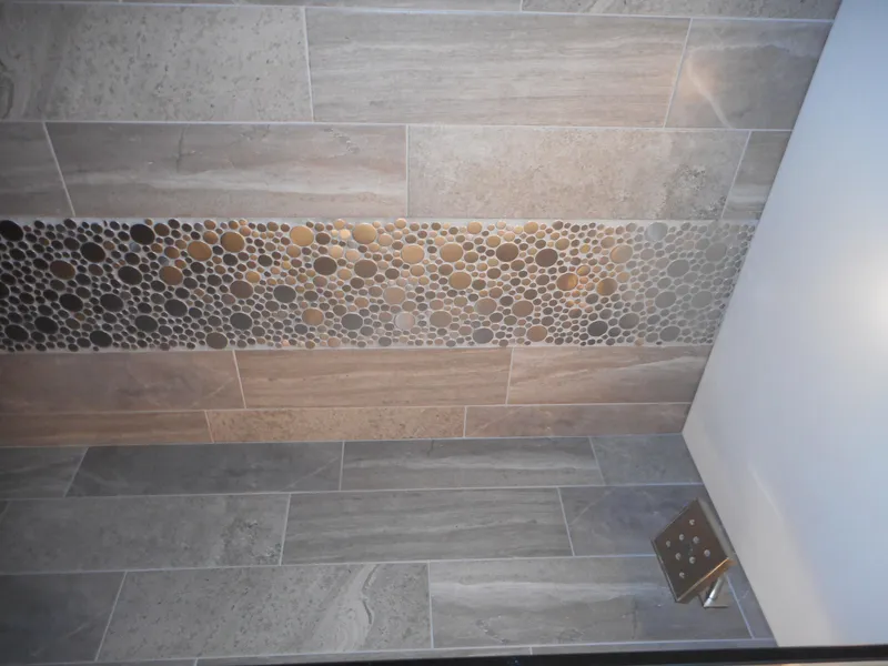 Slide: The Image of Shower wall with pebble mosaic accent and modern square showerhead, Adonia Liquidity Trip 5, 2017. - 10