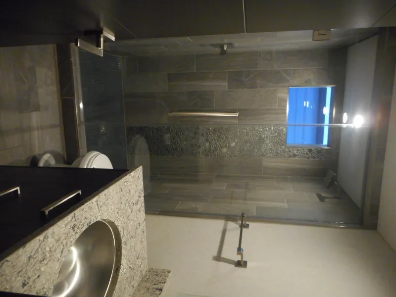 Slide: The Image of Modern bathroom with stone sink, glass shower, and sleek fixtures, Adonia Liquidity Trip 5, 2017. - 16