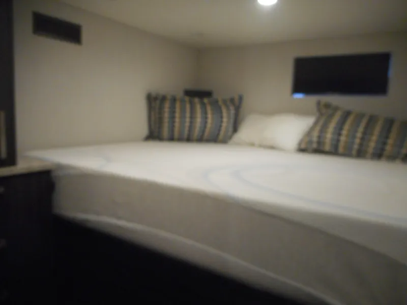 Slide: The Image of Cozy bedroom interior of 2017 Adonia Liquidity Trip 5 with striped pillows and soft lighting. - 17