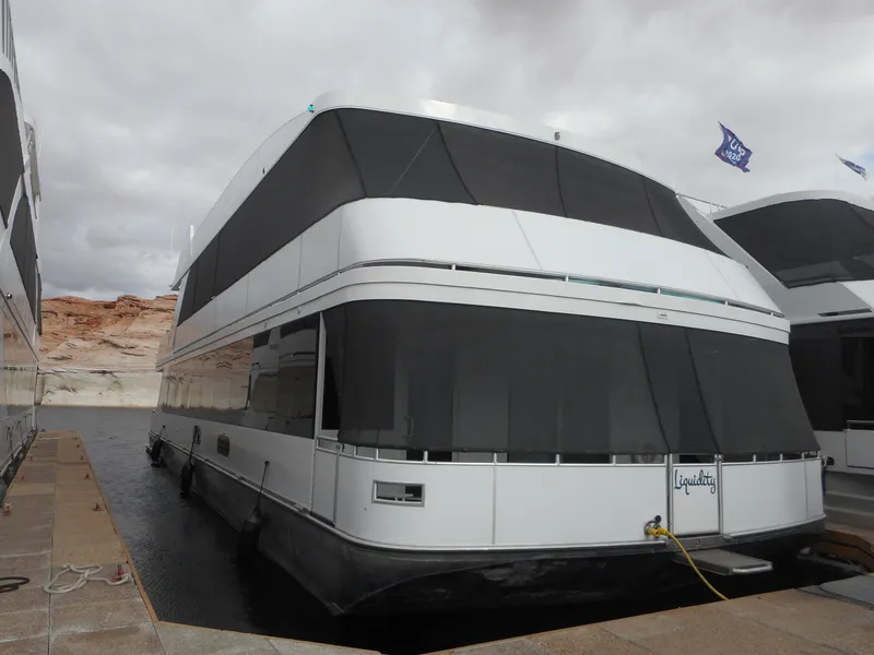 Slide: The Image of Houseboat docked at marina, Adonia Liquidity Trip 5, 2017 model, overcast sky. - 3