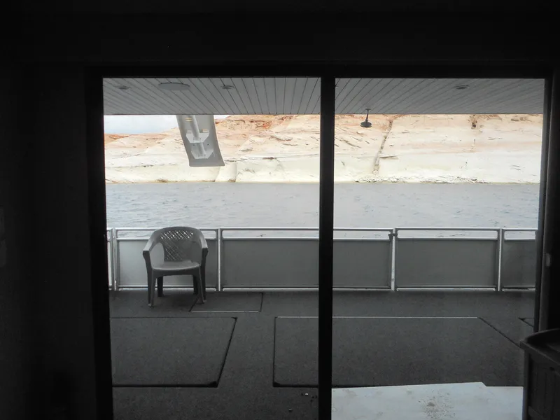 Slide: The Image of View from Adonia Liquidity Trip 5, 2017, showing a deck with a chair and water. - 32