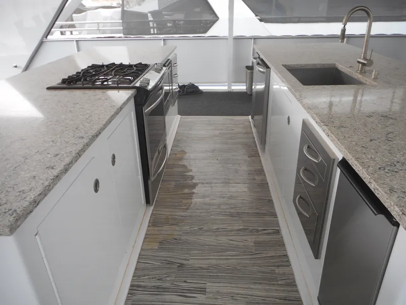 Slide: The Image of Modern kitchen on 2017 Adonia Liquidity Trip 5 yacht with granite countertops and stainless steel appliances. - 36