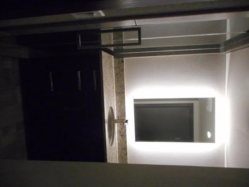 Slide: The Image of Modern bathroom with illuminated mirror and granite countertop, featuring Adonia Liquidity Trip 5 design. - 7