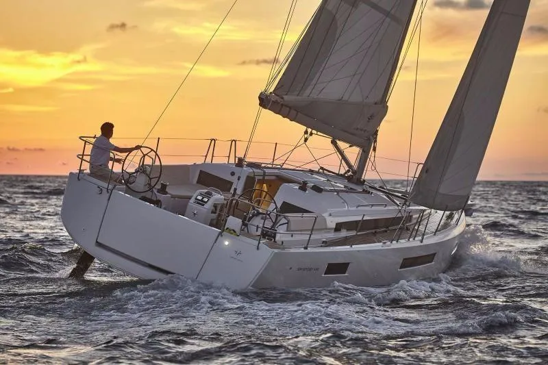 Slide: The Image of 2024 Jeanneau Sun Odyssey 440 sailing at sunset on open sea. - 1
