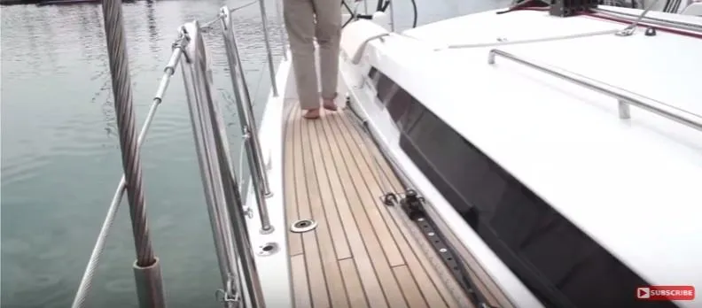 Slide: The Image of 2024 Jeanneau Sun Odyssey 440 yacht deck with teak flooring and railing. - 11