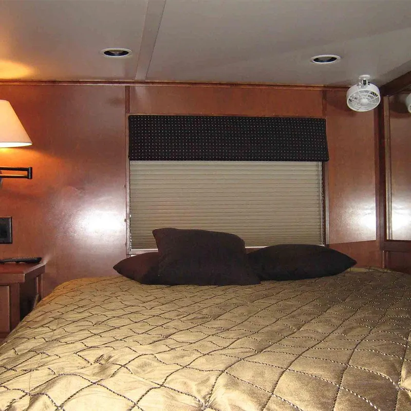 Slide: The Image of Cozy bedroom interior of 2010 Bravada Houseboat Dream Catcher SHARE #16 with warm lighting. - 5