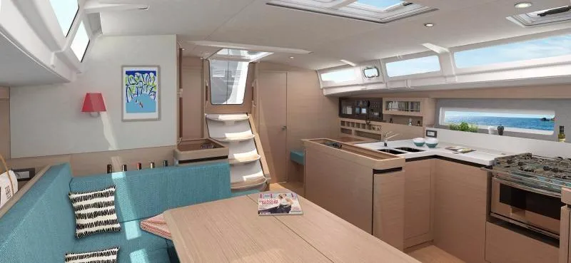 Slide: The Image of 2024 Jeanneau Sun Odyssey 490 interior with modern kitchen and seating area. - 3