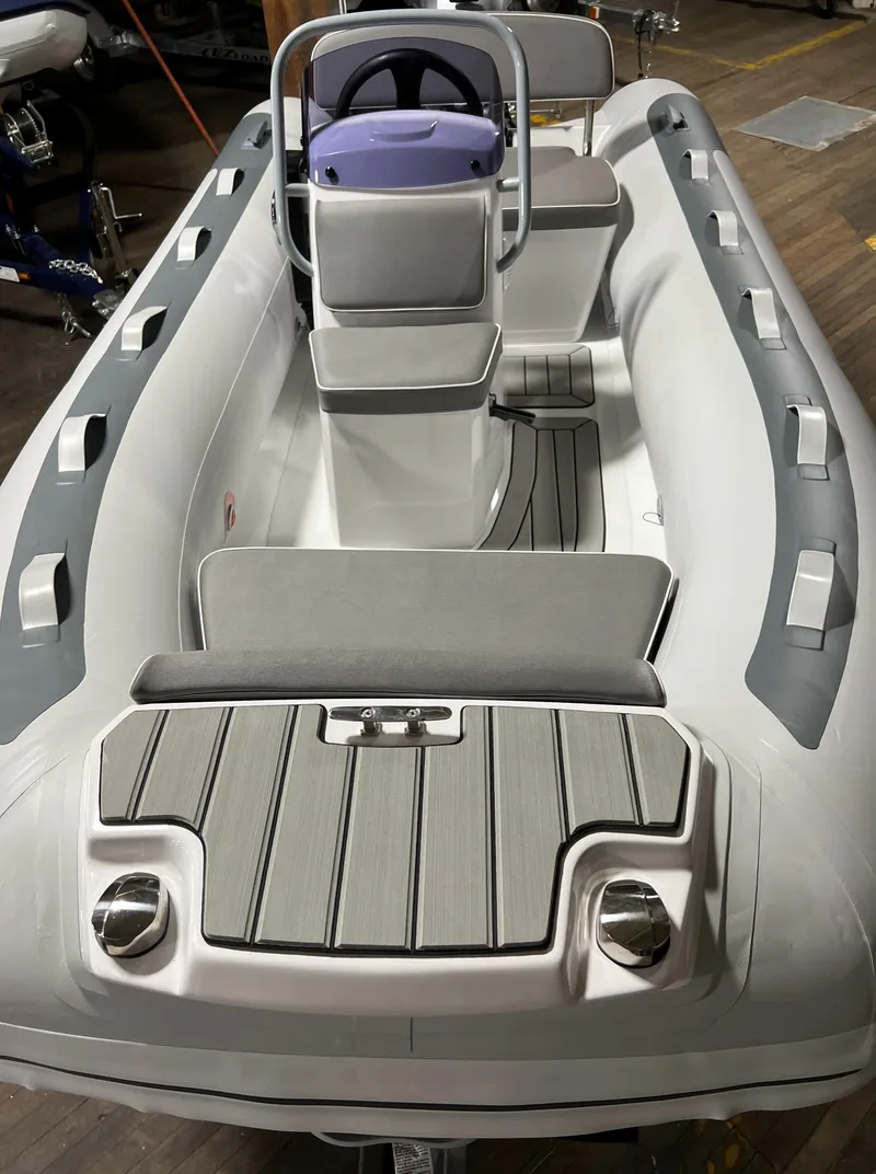 Slide: The Image of 2023 Gala A330L inflatable boat with seating and steering console. - 2