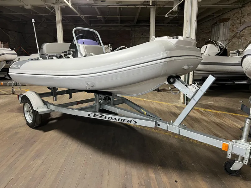 Slide: The Image of 2023 Gala A330L inflatable boat on EZ Loader trailer in warehouse. - 3