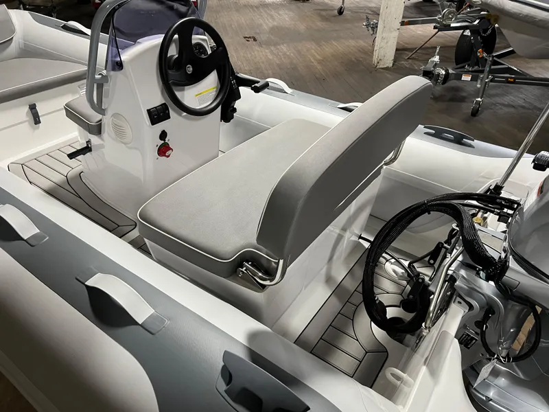 Slide: The Image of 2023 Gala A330L inflatable boat interior with steering console and seating. - 4