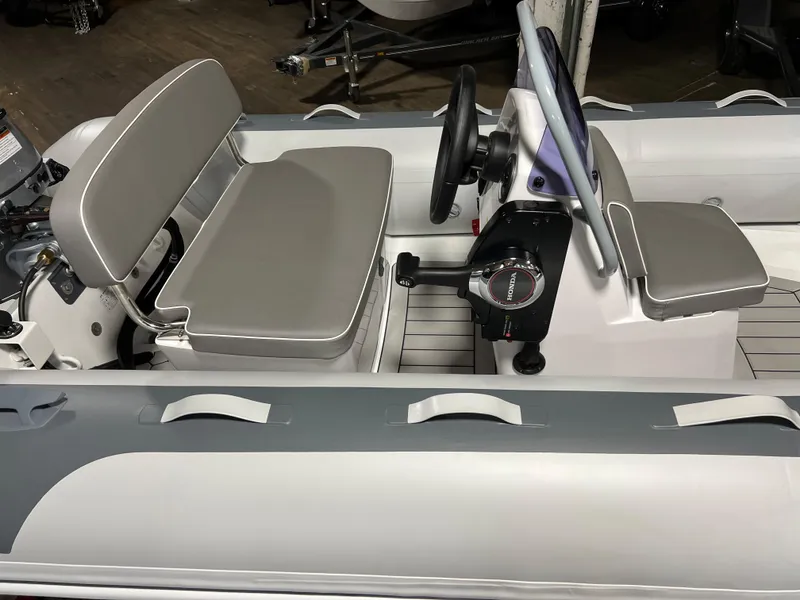 Slide: The Image of 2023 Gala A330L inflatable boat with grey seating and steering console. - 5