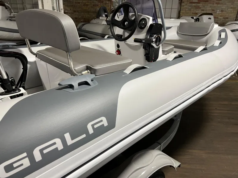Slide: The Image of 2023 Gala A330L inflatable boat with steering console and seating. - 6