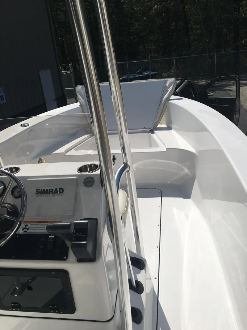 Slide: The Image of 2018 Sportsman Island Reef 19 Center Console boat interior with steering console and seating. - 2