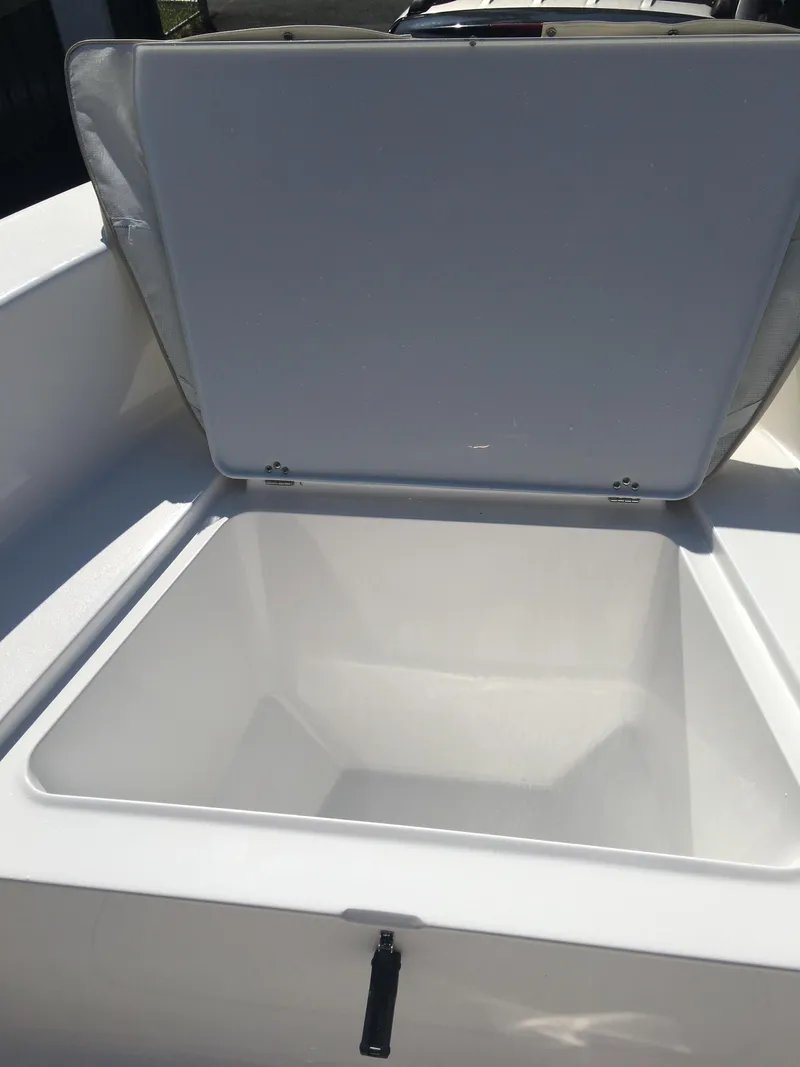 Slide: The Image of 2018 Sportsman Island Reef 19 Center Console storage compartment open. - 4