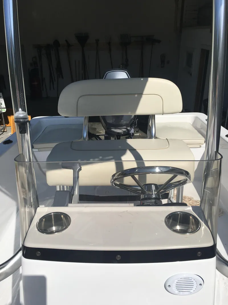 Slide: The Image of 2018 Sportsman Island Reef 19 Center Console boat interior with steering wheel and seating. - 6