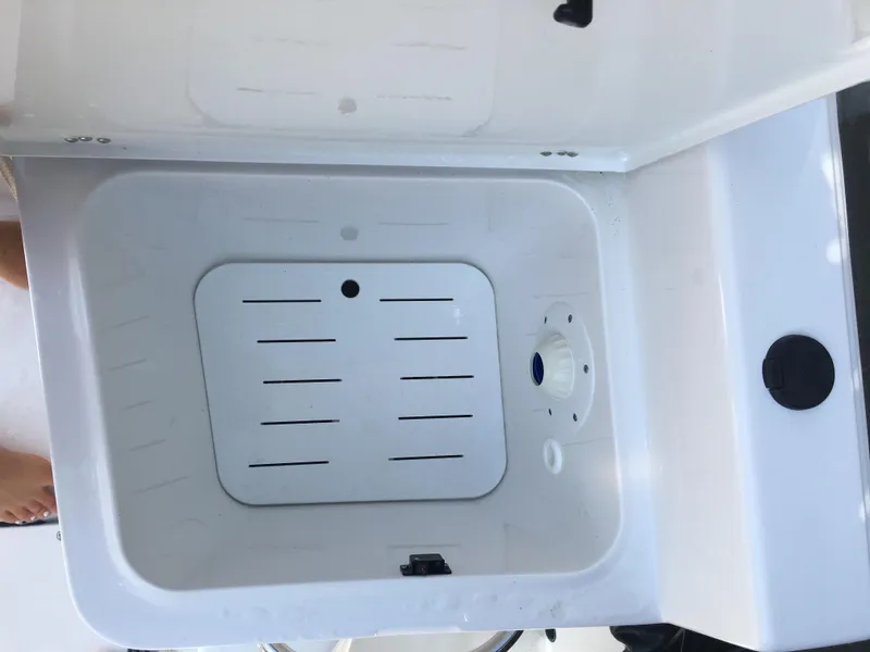 Slide: The Image of Open storage compartment on 2018 Sportsman Island Reef 19 Center Console boat. - 9