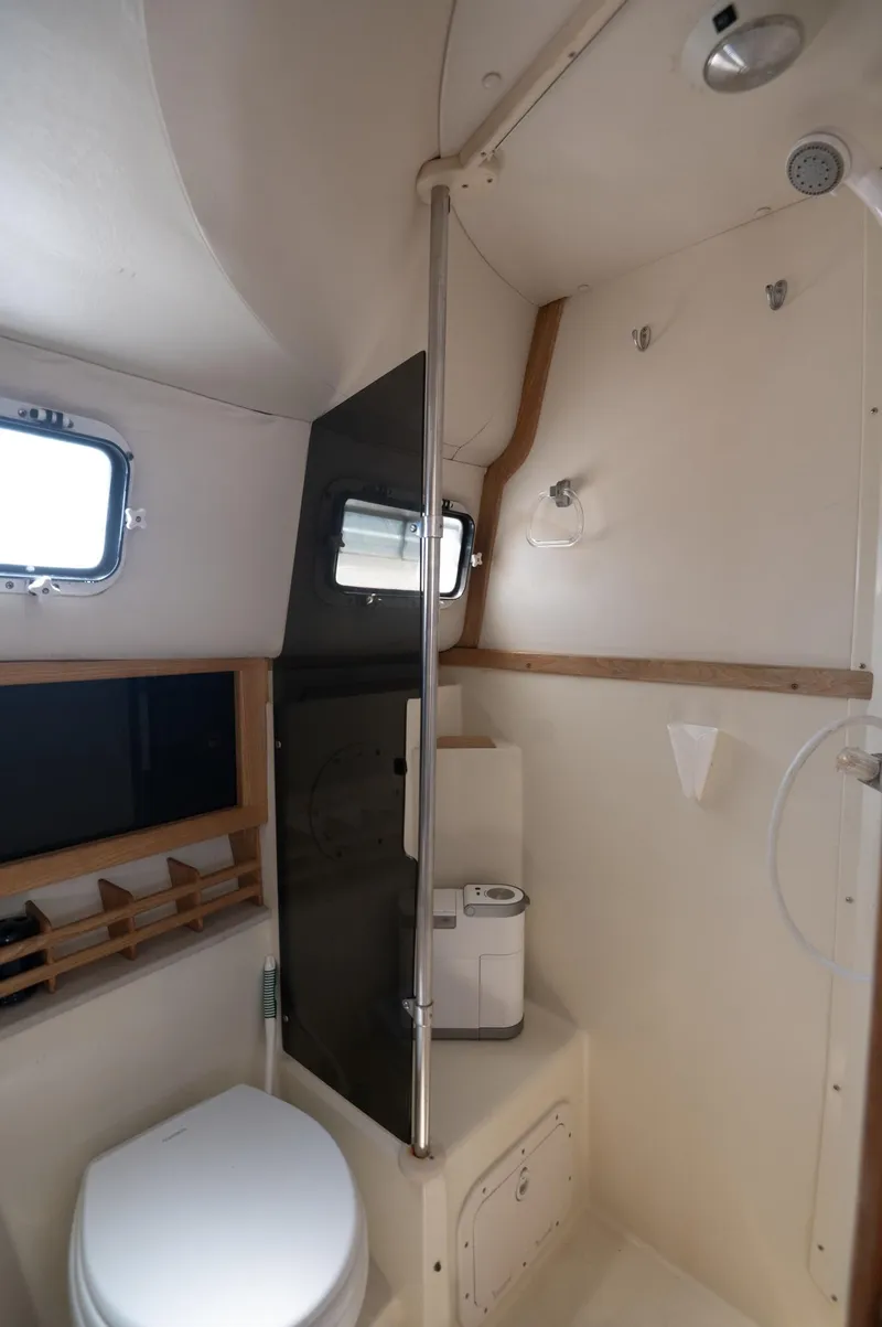 Slide: The Image of 1996 Albin 32 Command Bridge bathroom with shower, toilet, and window. - 10