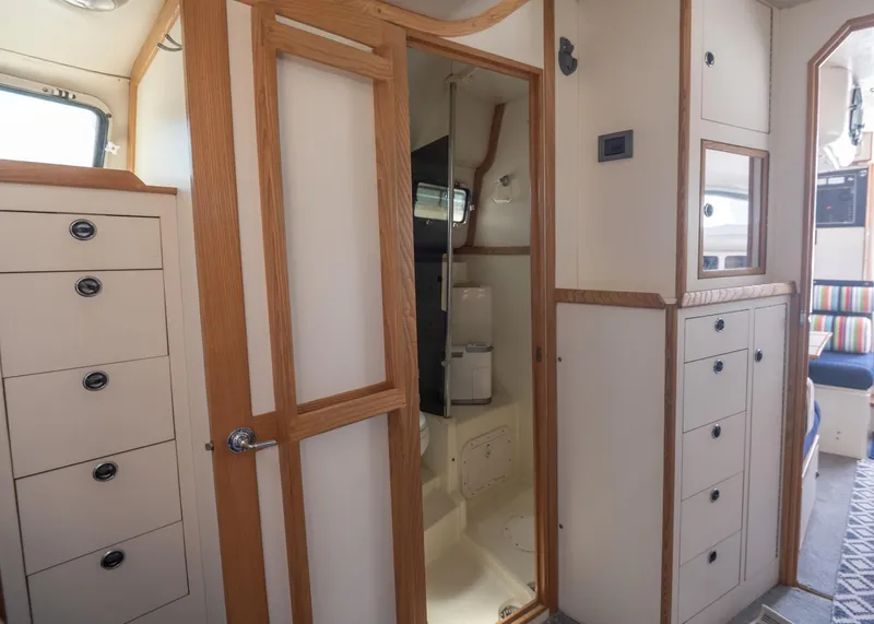 Slide: The Image of Interior of 1996 Albin 32 Command Bridge, featuring wood accents and ample storage. - 11