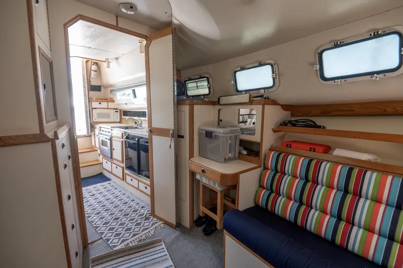 Slide: The Image of Interior of a 1996 Albin 32 Command Bridge boat with kitchen and seating area. - 13