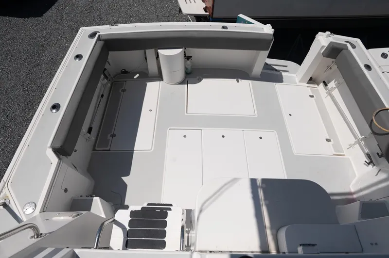 Slide: The Image of 1996 Albin 32 Command Bridge boat deck with seating and storage compartments. - 17