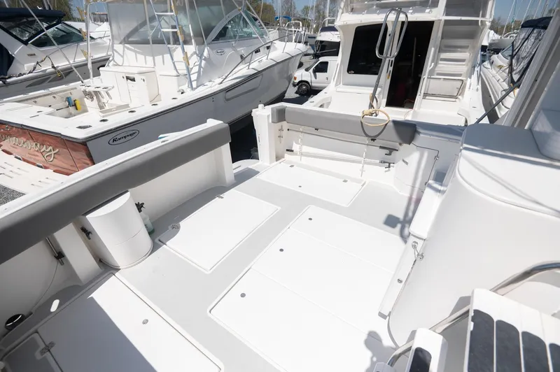 Slide: The Image of 1996 Albin 32 Command Bridge boat deck, featuring spacious seating and clean design. - 18