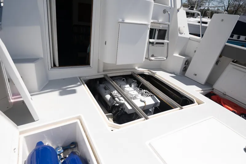 Slide: The Image of 1996 Albin 32 Command Bridge engine compartment with open hatches, showcasing the boat's interior mechanics. - 21