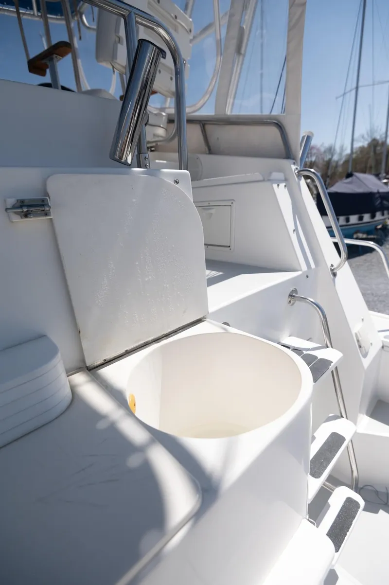 Slide: The Image of 1996 Albin 32 Command Bridge boat deck with storage compartments and seating. - 22