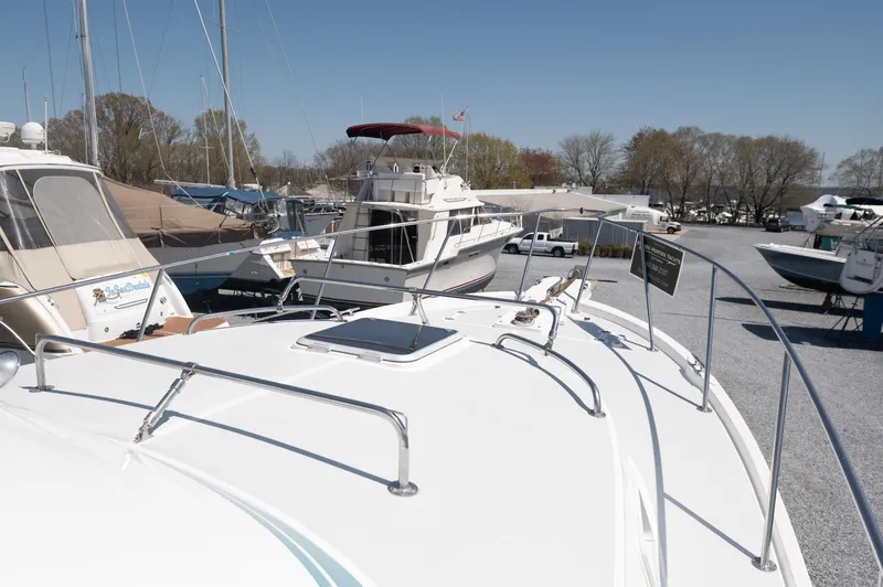 Slide: The Image of 1996 Albin 32 Command Bridge yacht docked in a marina under clear skies. - 24