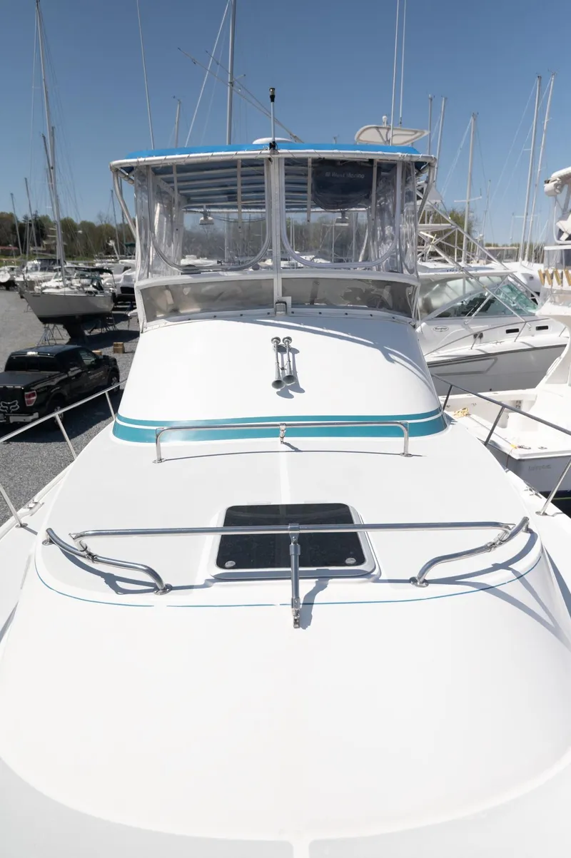 Slide: The Image of 1996 Albin 32 Command Bridge boat with sleek design, docked in a marina. - 26