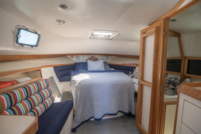 Slide: The Image of Cozy cabin interior of 1996 Albin 32 Command Bridge with bed and seating area. - 9
