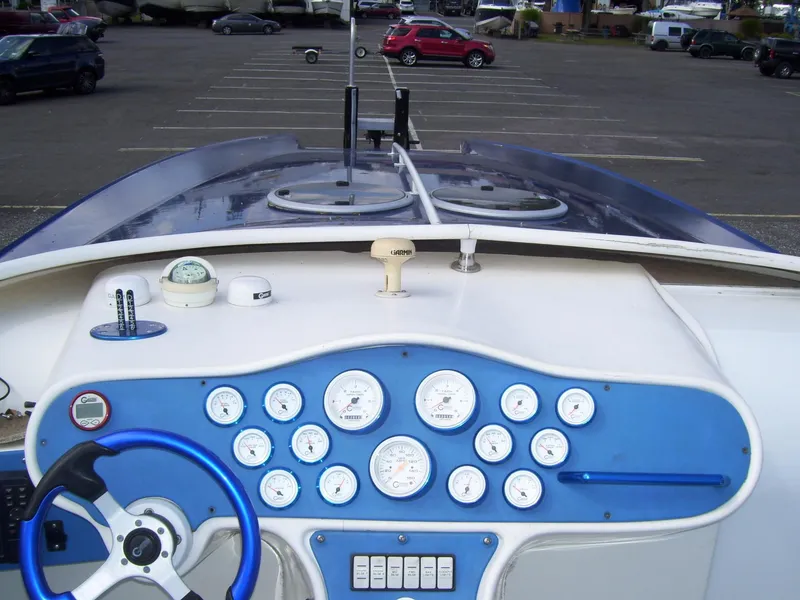 Slide: The Image of Control panel of a 2002 Mares 38 High Performance boat in a parking lot. - 12