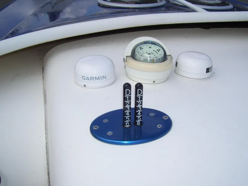 Slide: The Image of Boat dashboard with compass, Garmin device, and controls on a 2002 Mares 38 High Performance. - 15