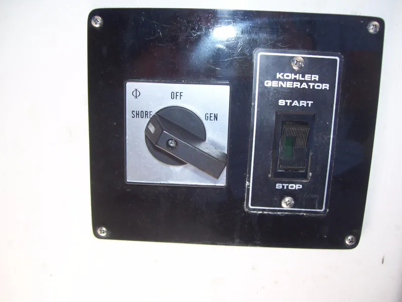 Slide: The Image of Control panel with Kohler generator switch on a 2002 Mares 38 High Performance boat. - 19